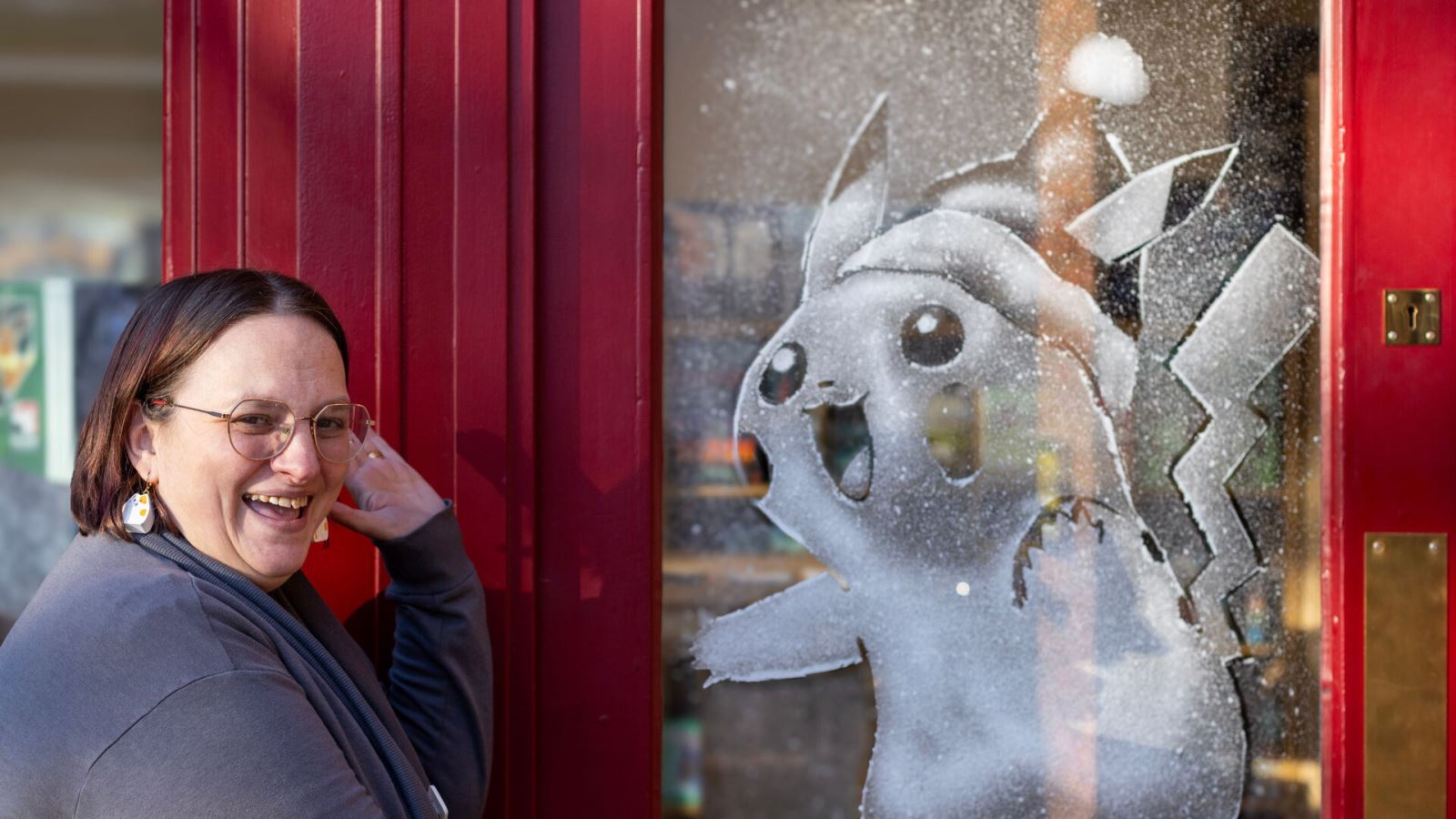 Woman next to Pikachu snow window